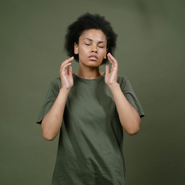 Person meditating peacefully with a calm and focused expression.